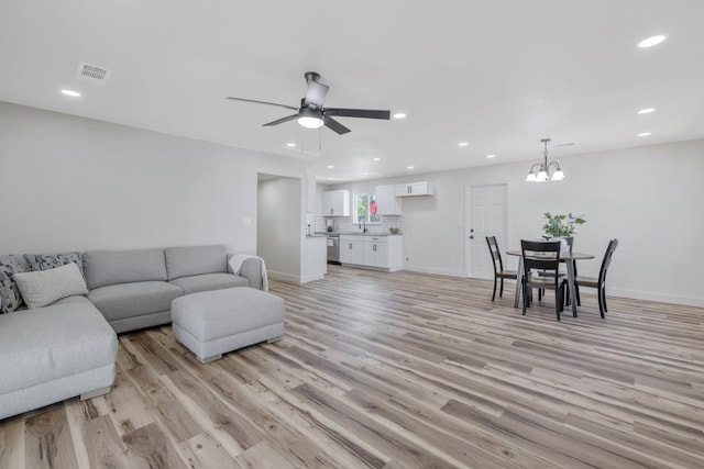 336 W Locust Ave, Pinedale, CA 93650 - living room featuring light wood-style floors, recessed lighting, ceiling fan, a chandelier, and baseboards