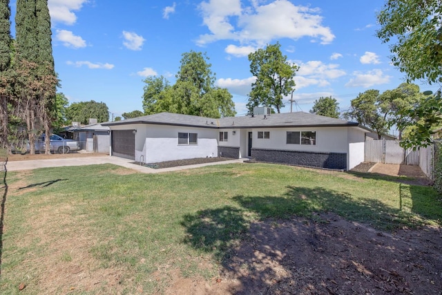 336 W Locust Ave, Pinedale, CA 93650 - back of property featuring an attached garage, stucco siding, concrete driveway, and brick siding