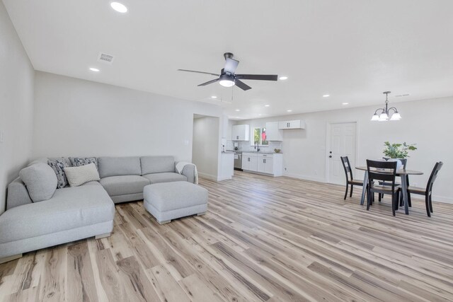 336 W Locust Ave, Pinedale, CA 93650 - living room featuring light wood-type flooring, recessed lighting, a chandelier, a ceiling fan, and baseboards