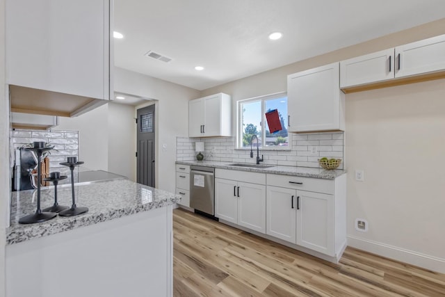336 W Locust Ave, Pinedale, CA 93650 - kitchen featuring a sink, dishwasher, light wood-style floors, white cabinetry, and decorative backsplash
