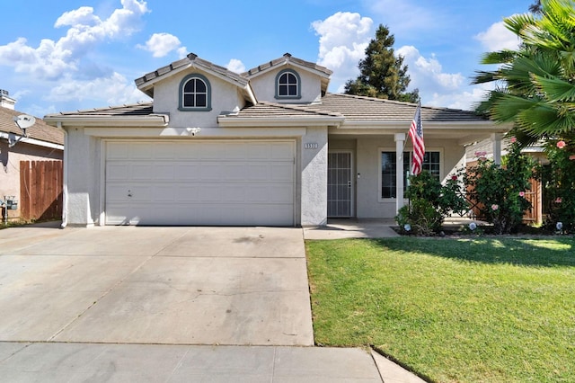 5532 W Indianapolis Ave, Fresno, CA 93722 - view of front facade with stucco siding, driveway, a garage, and a tiled roof