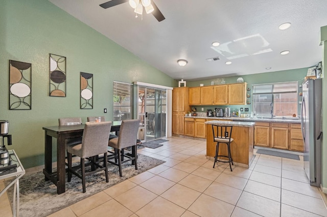 5532 W Indianapolis Ave, Fresno, CA 93722 - dining area featuring vaulted ceiling, light tile patterned floors, a ceiling fan, and recessed lighting