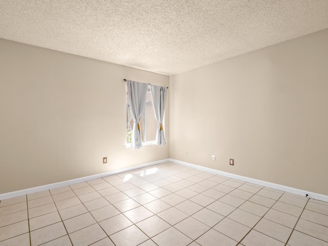 1550 W Ashlan Ave Unit 241, Fresno, CA 93705 - spare room with a textured ceiling, light tile patterned floors, and baseboards