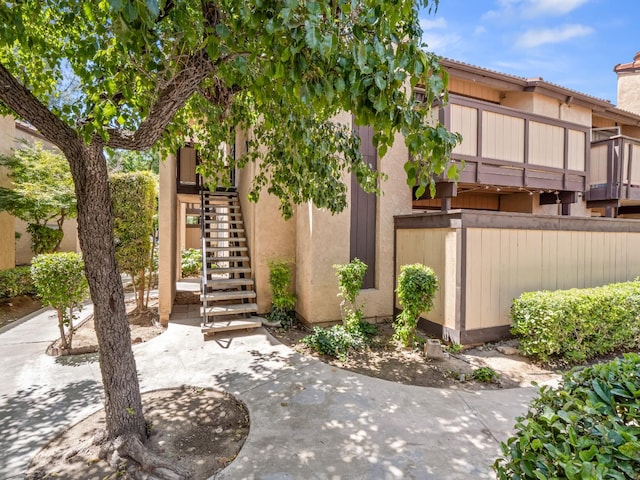 1550 W Ashlan Ave Unit 241, Fresno, CA 93705 - view of front of house with stairway and stucco siding