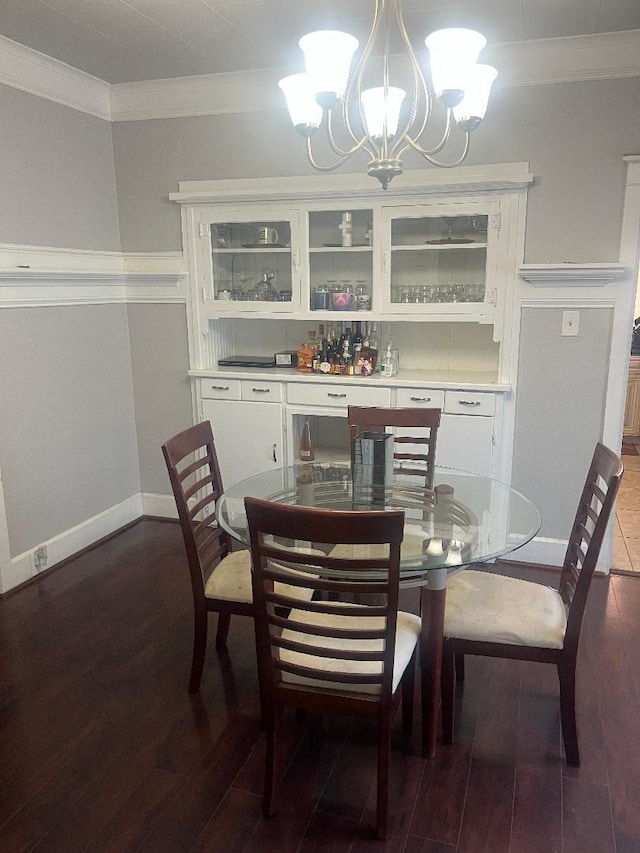 814 N Roosevelt Ave, Fresno, CA 93728 - dining space with crown molding, a chandelier, wood finished floors, and baseboards