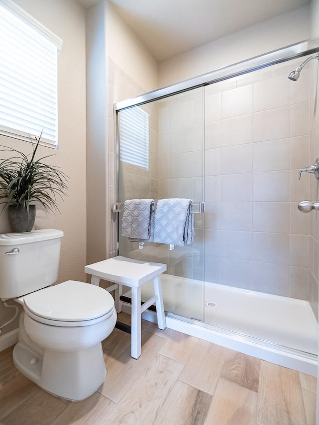 873 Beaver Pond Loop, Madera, CA 93636 - bathroom featuring a shower stall, wood finished floors, and toilet