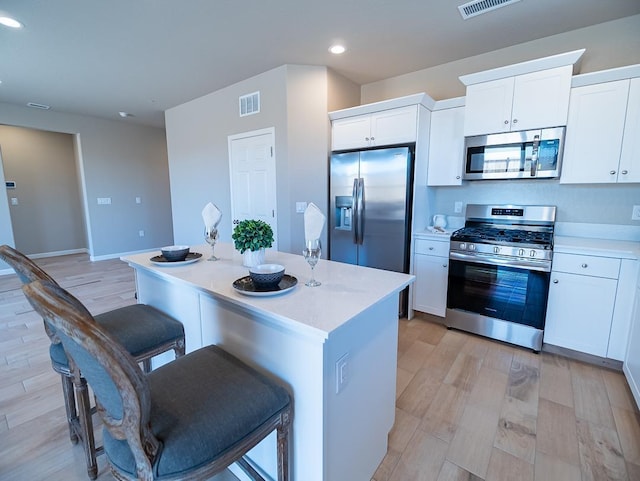 873 Beaver Pond Loop, Madera, CA 93636 - kitchen with appliances with stainless steel finishes, recessed lighting, a center island, light wood finished floors, and white cabinets