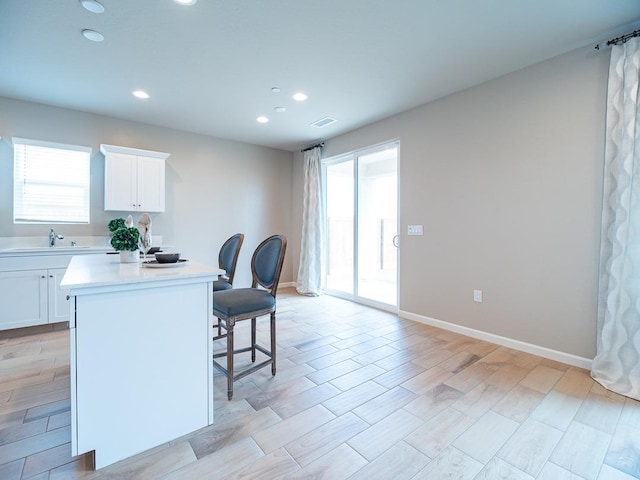 873 Beaver Pond Loop, Madera, CA 93636 - kitchen with a kitchen breakfast bar, plenty of natural light, light countertops, recessed lighting, and a center island