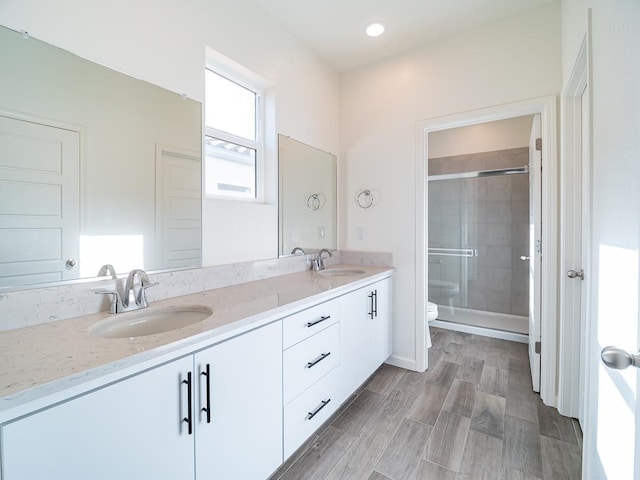 878 Beaver Pond Loop, Madera, CA 93636 - bathroom with toilet, a stall shower, double vanity, wood finished floors, and recessed lighting