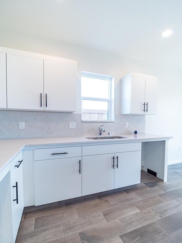 878 Beaver Pond Loop, Madera, CA 93636 - kitchen with a sink, white cabinets, light countertops, and decorative backsplash