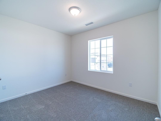878 Beaver Pond Loop, Madera, CA 93636 - empty room featuring dark colored carpet and baseboards