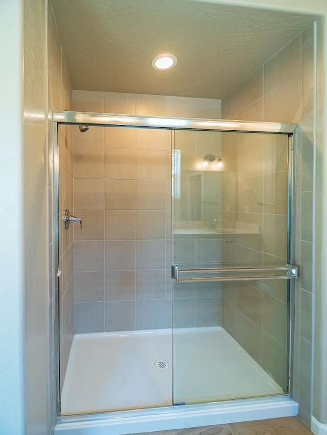 917 Beaver Pond Loop, Madera, CA 93636 - full bath featuring a stall shower, a textured ceiling, and recessed lighting