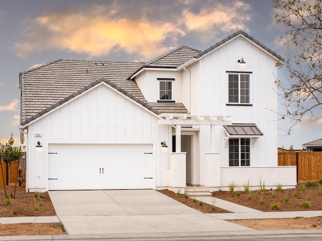 917 Beaver Pond Loop, Madera, CA 93636 - modern farmhouse style home featuring board and batten siding, fence, concrete driveway, a tile roof, and a garage