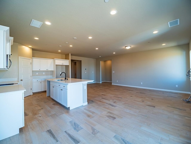 917 Beaver Pond Loop, Madera, CA 93636 - kitchen with a sink, open floor plan, an island with sink, light countertops, and recessed lighting