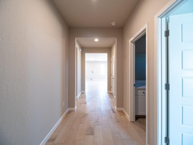917 Beaver Pond Loop, Madera, CA 93636 - hall with light wood finished floors, baseboards, and recessed lighting