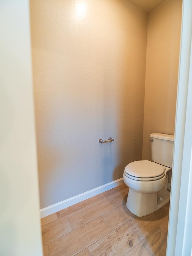 917 Beaver Pond Loop, Madera, CA 93636 - bathroom with toilet, wood finished floors, and baseboards