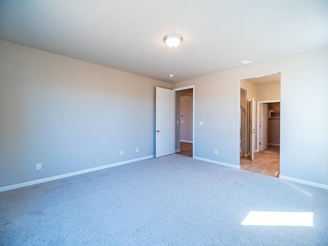 917 Beaver Pond Loop, Madera, CA 93636 - unfurnished bedroom featuring carpet floors, baseboards, and a walk in closet