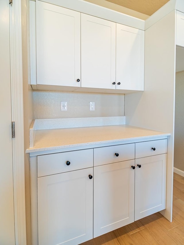 917 Beaver Pond Loop, Madera, CA 93636 - kitchen with white cabinetry and light wood-style flooring