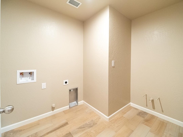 917 Beaver Pond Loop, Madera, CA 93636 - washroom with hookup for a gas dryer, light wood-style flooring, electric dryer hookup, and hookup for a washing machine