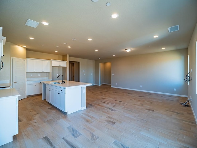917 Beaver Pond Loop, Madera, CA 93636 - kitchen with a sink, open floor plan, white cabinetry, recessed lighting, and light wood-type flooring