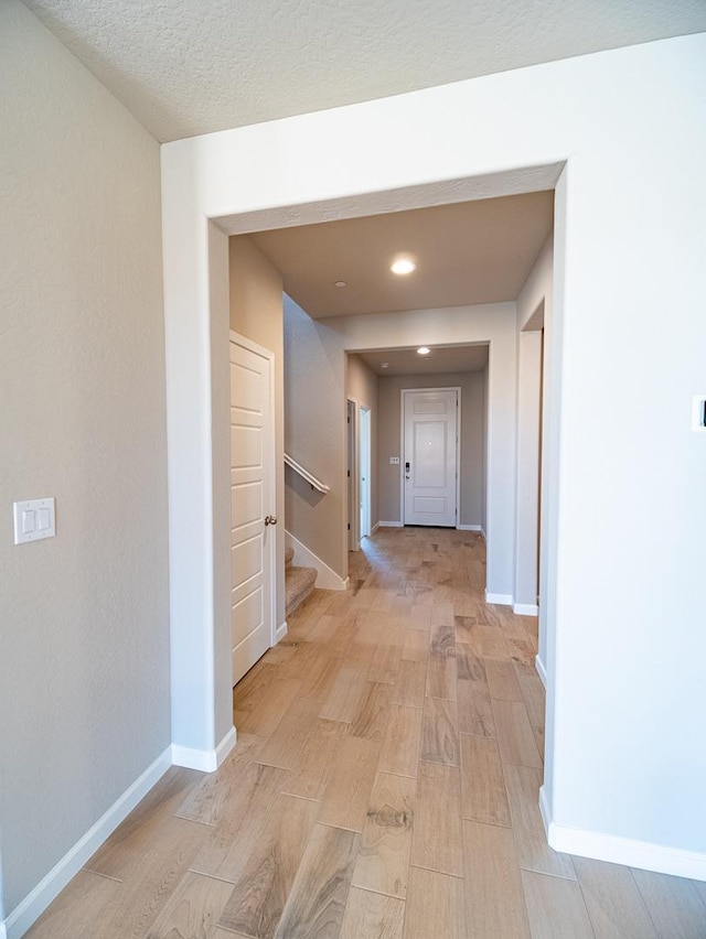 917 Beaver Pond Loop, Madera, CA 93636 - corridor featuring light wood-style flooring, baseboards, stairs, and recessed lighting