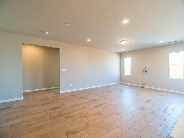 917 Beaver Pond Loop, Madera, CA 93636 - empty room with light wood-type flooring, recessed lighting, baseboards, and a textured ceiling