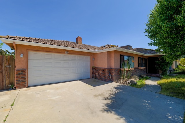 ranch-style house featuring brick siding, concrete driveway, a chimney, an attached garage, and a tile roof