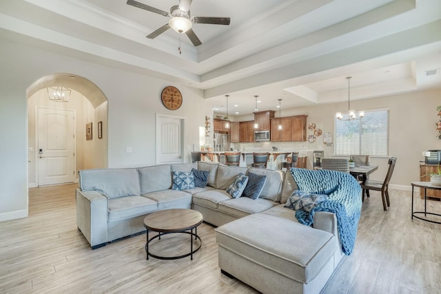 716 Mesa Dr S, Madera, CA 93636 - living room with a tray ceiling, light wood finished floors, a ceiling fan, a chandelier, and ornamental molding