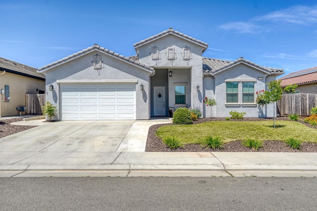 716 Mesa Dr S, Madera, CA 93636 - view of front of home with stucco siding, driveway, a garage, and a tiled roof
