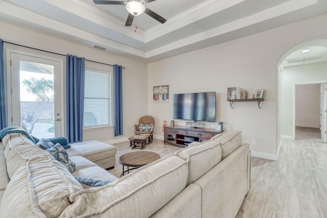 716 Mesa Dr S, Madera, CA 93636 - living room with light wood-type flooring, arched walkways, ceiling fan, ornamental molding, and a tray ceiling