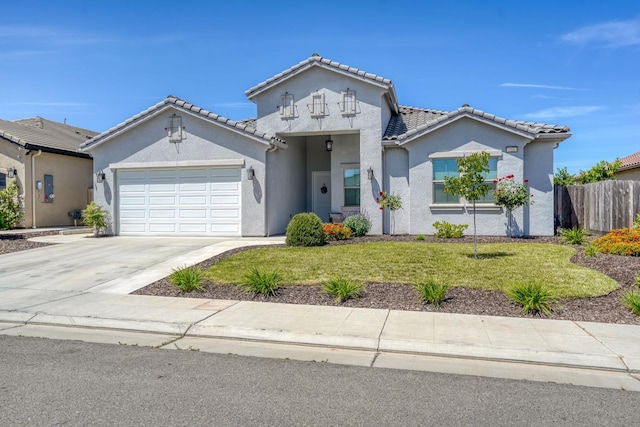 716 Mesa Dr S, Madera, CA 93636 - view of front of property with stucco siding, an attached garage, driveway, and a tile roof