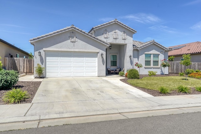 716 Mesa Dr S, Madera, CA 93636 - view of front of home with concrete driveway, stucco siding, a garage, and a tile roof