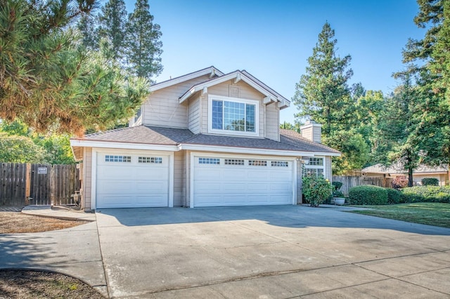 580 W Alluvial Ave, Clovis, CA 93611 - traditional-style house featuring driveway, fence, an attached garage, and a chimney