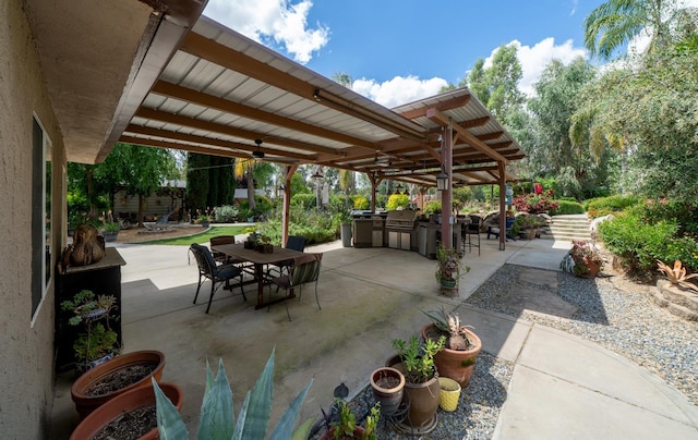 view of patio / terrace with an outdoor kitchen, outdoor dining area, and a grill