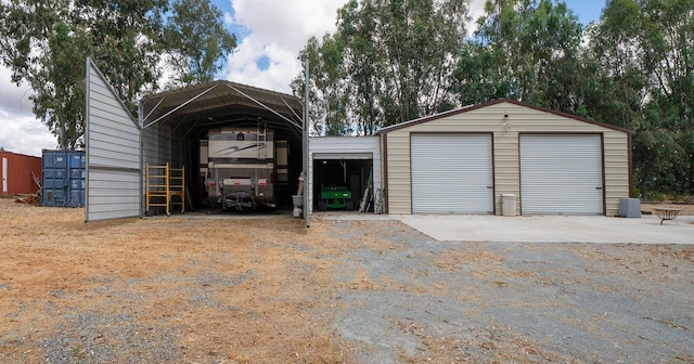 garage with a detached garage and a detached carport