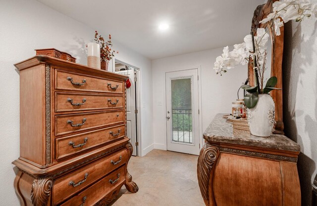 doorway to outside with light colored carpet and baseboards