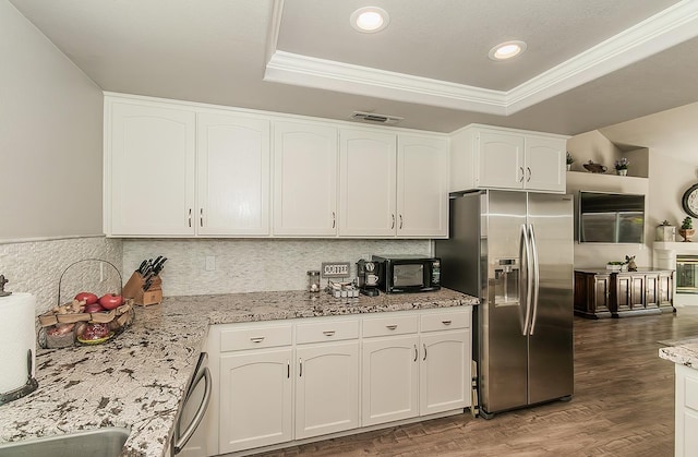 1073 E Pennsylvania Ave, Fresno, CA 93720 - kitchen with appliances with stainless steel finishes, a tray ceiling, white cabinetry, ornamental molding, and wood finished floors