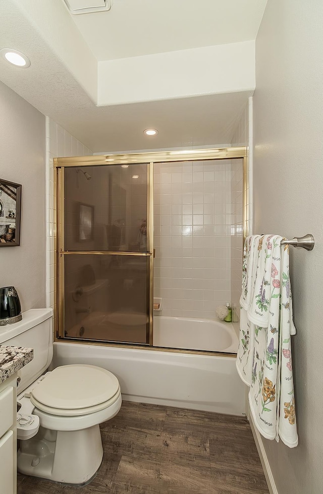 1073 E Pennsylvania Ave, Fresno, CA 93720 - full bath with wood finished floors, combined bath / shower with glass door, toilet, and recessed lighting