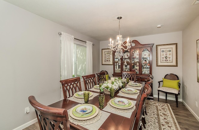 1073 E Pennsylvania Ave, Fresno, CA 93720 - dining area with a chandelier, dark wood-style floors, and baseboards