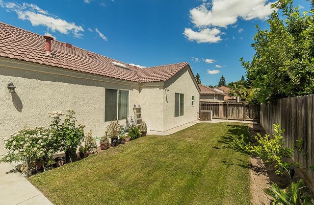 1073 E Pennsylvania Ave, Fresno, CA 93720 - back of property with a tiled roof, stucco siding, and central AC