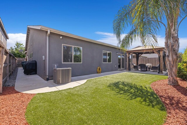6772 E Ramona Way, Fresno, CA 93727 - back of property with cooling unit, a gazebo, a patio area, stucco siding, and an outdoor hangout area