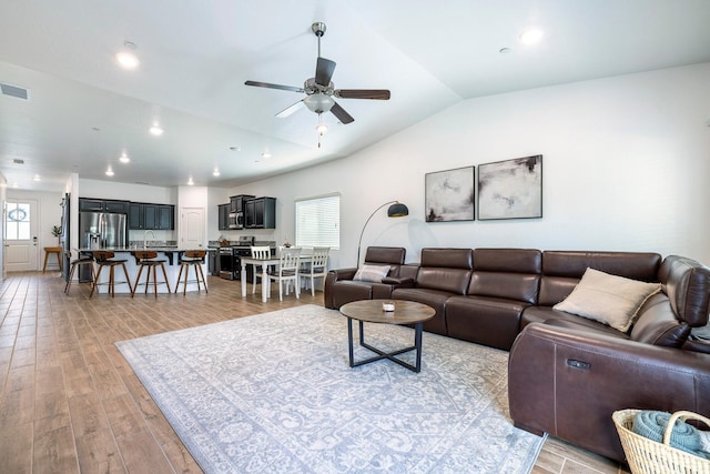 6772 E Ramona Way, Fresno, CA 93727 - living area with ceiling fan, light wood-style flooring, vaulted ceiling, and recessed lighting
