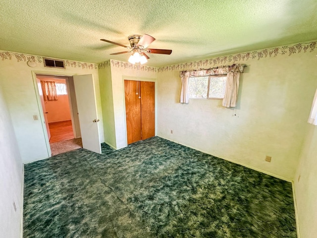 1482 W Thurman, Porterville, CA 93257 - unfurnished bedroom with carpet, a closet, multiple windows, a textured ceiling, and a ceiling fan