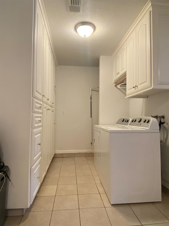 1035 Hoover Way, Hanford, CA 93230 - clothes washing area with washer and clothes dryer, light tile patterned floors, cabinet space, baseboards, and a textured ceiling