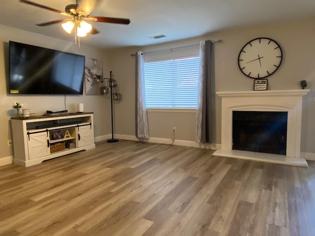 1035 Hoover Way, Hanford, CA 93230 - living area featuring a ceiling fan, light wood finished floors, and baseboards
