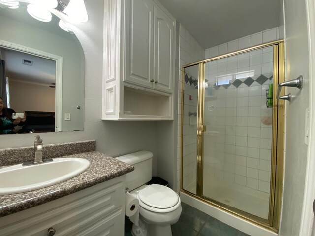1035 Hoover Way, Hanford, CA 93230 - full bathroom with a shower stall, toilet, vanity, and tile patterned floors