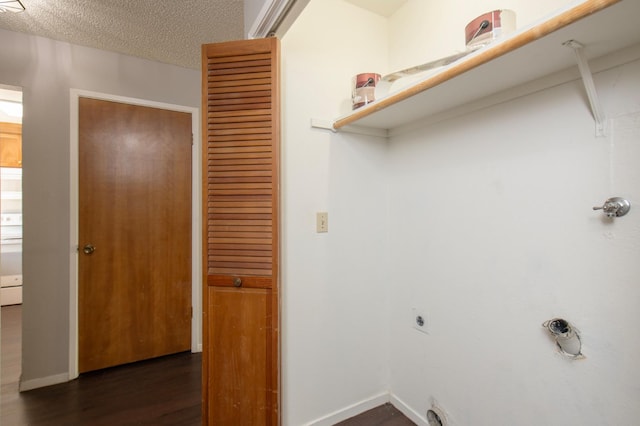 laundry area with electric dryer hookup, baseboards, dark wood finished floors, and a textured ceiling