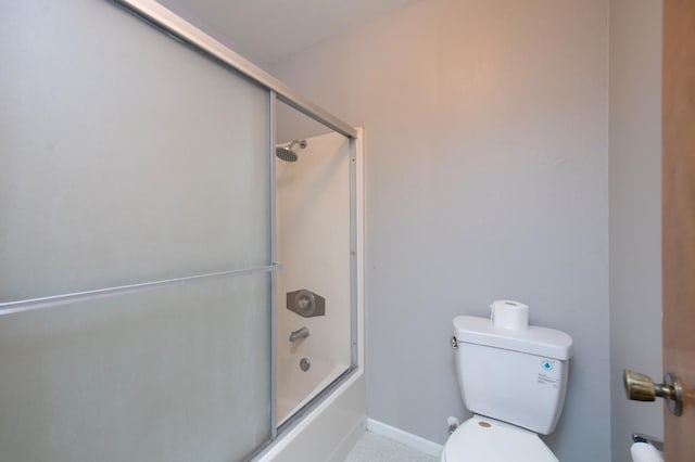 bathroom with toilet, combined bath / shower with glass door, and baseboards