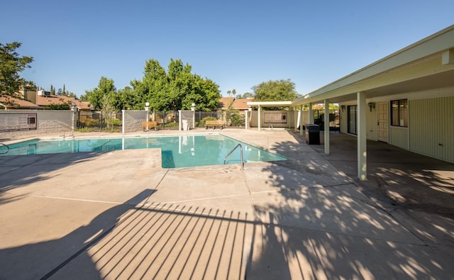 community pool featuring a patio and fence