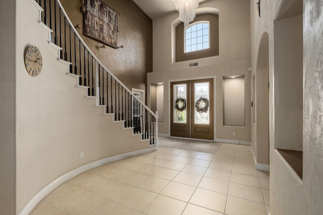 1710 N Filbert Ave, Clovis, CA 93619 - tiled entrance foyer with stairs, a towering ceiling, french doors, a chandelier, and baseboards